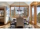 Cozy dining area features a round table, four chairs, and a large window at 1052 Country Club Estates Dr, Castle Rock, CO 80108
