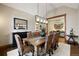 Formal dining room with seating for eight, elegant lighting, and hardwood floors at 1052 Country Club Estates Dr, Castle Rock, CO 80108