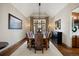 Formal dining room with seating for eight, elegant lighting, and a decorative mirror at 1052 Country Club Estates Dr, Castle Rock, CO 80108
