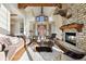 Grand living room with stone fireplace, vaulted ceilings, and large windows at 1052 Country Club Estates Dr, Castle Rock, CO 80108