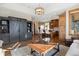 Spacious living area with wood floors, built-in cabinets, and kitchen island in background at 1052 Country Club Estates Dr, Castle Rock, CO 80108