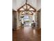 Elegant living room with soaring ceilings, exposed wood beams, stone columns, and a large window offering scenic views at 1052 Country Club Estates Dr, Castle Rock, CO 80108