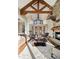 Spacious living room featuring a stone fireplace, exposed beams, and ample seating for relaxation and entertainment at 1052 Country Club Estates Dr, Castle Rock, CO 80108