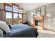 Inviting bedroom features a fireplace, a leather chair and doors leading to a balcony at 1052 Country Club Estates Dr, Castle Rock, CO 80108