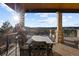 Relaxing covered patio offers mountain views and outdoor dining at 1052 Country Club Estates Dr, Castle Rock, CO 80108
