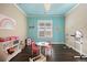 Bright playroom with a sky blue ceiling, hardwood floors, and a variety of toys at 1052 Country Club Estates Dr, Castle Rock, CO 80108
