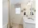 Bathroom featuring double sinks, modern fixtures, neutral walls, and a shower with a curtain at 22323 E 6Th Pl, Aurora, CO 80018
