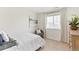 Comfortable bedroom with a cozy chair, neutral walls, plush carpet, and a large window at 22323 E 6Th Pl, Aurora, CO 80018