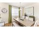 Dining area boasts elegant chandelier, wooden table, and large picture window at 22323 E 6Th Pl, Aurora, CO 80018