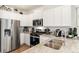 Modern kitchen showcasing stainless steel appliances, granite countertops, and white cabinetry at 22323 E 6Th Pl, Aurora, CO 80018