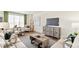 Spacious living area featuring a modern entertainment center, plush seating, and stylish decor at 22323 E 6Th Pl, Aurora, CO 80018