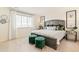 Bright primary bedroom with decorative pillows, green accents and window at 22323 E 6Th Pl, Aurora, CO 80018