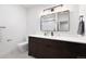 A modern bathroom is presented with a dark wood vanity, white countertop, and rectangular mirror, creating a sophisticated aesthetic at 19 Washington Ave, Golden, CO 80403