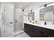 Modern bathroom featuring a glass-enclosed shower and a dual sink vanity with dark wood cabinets at 19 Washington Ave, Golden, CO 80403