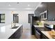 Beautiful open kitchen with white countertops, dark cabinets, stainless steel appliances, and pendant lights at 19 Washington Ave, Golden, CO 80403