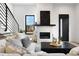 Bright living room with a stone fireplace, modern black windows, and a comfortable sectional sofa at 19 Washington Ave, Golden, CO 80403