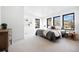 Bright and airy bedroom with soft carpet, multiple windows with views, and contemporary furnishings at 19 Washington Ave, Golden, CO 80403