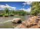 Scenic river view with rock formations, lush trees, and people enjoying a sunny day at 19 Washington Ave, Golden, CO 80403