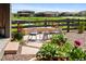 Private backyard featuring a stone patio with seating and lush landscaping at 6530 Barnstead Dr, Castle Pines, CO 80108