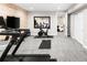 Finished basement with a home gym featuring a treadmill, stationary bike, and workout equipment at 6530 Barnstead Dr, Castle Pines, CO 80108