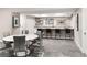 Basement area with bar, seating, decor, and plenty of room to relax or entertain at 6530 Barnstead Dr, Castle Pines, CO 80108
