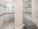 Modern bathroom boasting frameless glass shower doors, tiled walls, and built-in bench at 6530 Barnstead Dr, Castle Pines, CO 80108