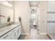 Primary bathroom showcasing granite countertop vanity and glass shower stall near bedroom entrance at 6530 Barnstead Dr, Castle Pines, CO 80108