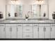Bright bathroom featuring double vanity with granite countertop and dual undermount sinks at 6530 Barnstead Dr, Castle Pines, CO 80108