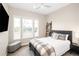 Cozy bedroom with a plaid blanket, dark wood furnishings, and lots of natural light at 6530 Barnstead Dr, Castle Pines, CO 80108
