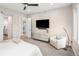 Modern bedroom featuring a sliding barn door to the bathroom and contemporary furnishings at 6530 Barnstead Dr, Castle Pines, CO 80108