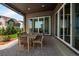 Relaxing outdoor patio features a dining table with seating, and a textured floor at 6530 Barnstead Dr, Castle Pines, CO 80108