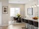 An elegant dining room features a modern chandelier and a table set for dinner at 6530 Barnstead Dr, Castle Pines, CO 80108