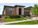 Modern home with a well-manicured lawn and beautiful landscaping adds curb appeal at 6530 Barnstead Dr, Castle Pines, CO 80108