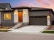Inviting single-Gathering home featuring modern design, brick accents, and a spacious driveway at 6530 Barnstead Dr, Castle Pines, CO 80108