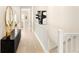 Bright hallway with modern decor, hardwood floors, and a staircase leading to the upper level at 6530 Barnstead Dr, Castle Pines, CO 80108