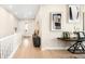 Long hallway with neutral paint and decor leading to a white front door at 6530 Barnstead Dr, Castle Pines, CO 80108