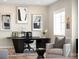 This home office boasts a unique desk, comfortable chair, and is decorated with modern art at 6530 Barnstead Dr, Castle Pines, CO 80108