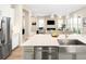 Bright, open kitchen with a stainless steel farm sink, quartz countertops, and a view of the living area at 6530 Barnstead Dr, Castle Pines, CO 80108