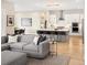 Open floor plan showcases the living room connecting to the kitchen with an island and barstool seating at 6530 Barnstead Dr, Castle Pines, CO 80108