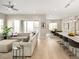 Open-concept living room flows into dining area and features plush seating and natural light at 6530 Barnstead Dr, Castle Pines, CO 80108