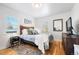 Spacious bedroom with hardwood floors and a wooden headboard at 3195 S Clarkson St, Englewood, CO 80113