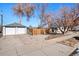 Two-car garage with driveway and wooden fence at 3195 S Clarkson St, Englewood, CO 80113