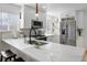 Modern kitchen with white cabinetry, quartz countertops, and stainless steel appliances at 3195 S Clarkson St, Englewood, CO 80113