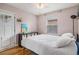 Bright bedroom featuring light pink walls, a ceiling fan, a comfy bed, and a window for natural light at 3640 N Saint Paul St, Denver, CO 80205