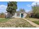 Charming single-story home with brick accents, a well-manicured lawn, and a welcoming teal front door at 3640 N Saint Paul St, Denver, CO 80205