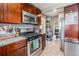 Well-equipped kitchen with stainless steel appliances, granite countertops, and dark wood cabinetry at 3640 N Saint Paul St, Denver, CO 80205
