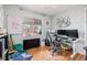 Well-lit home office with hardwood floors, modern desk setup, large window, and creative decor at 3640 N Saint Paul St, Denver, CO 80205