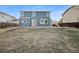 Backyard of a two-story home featuring a lawn and concrete patio at 13058 Monaco Way, Thornton, CO 80602