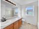 Bathroom has a large sink and vanity, with a window for natural light at 13058 Monaco Way, Thornton, CO 80602