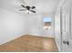 Bedroom with hardwood floors, a ceiling fan, a window, and a door to the closet at 13058 Monaco Way, Thornton, CO 80602